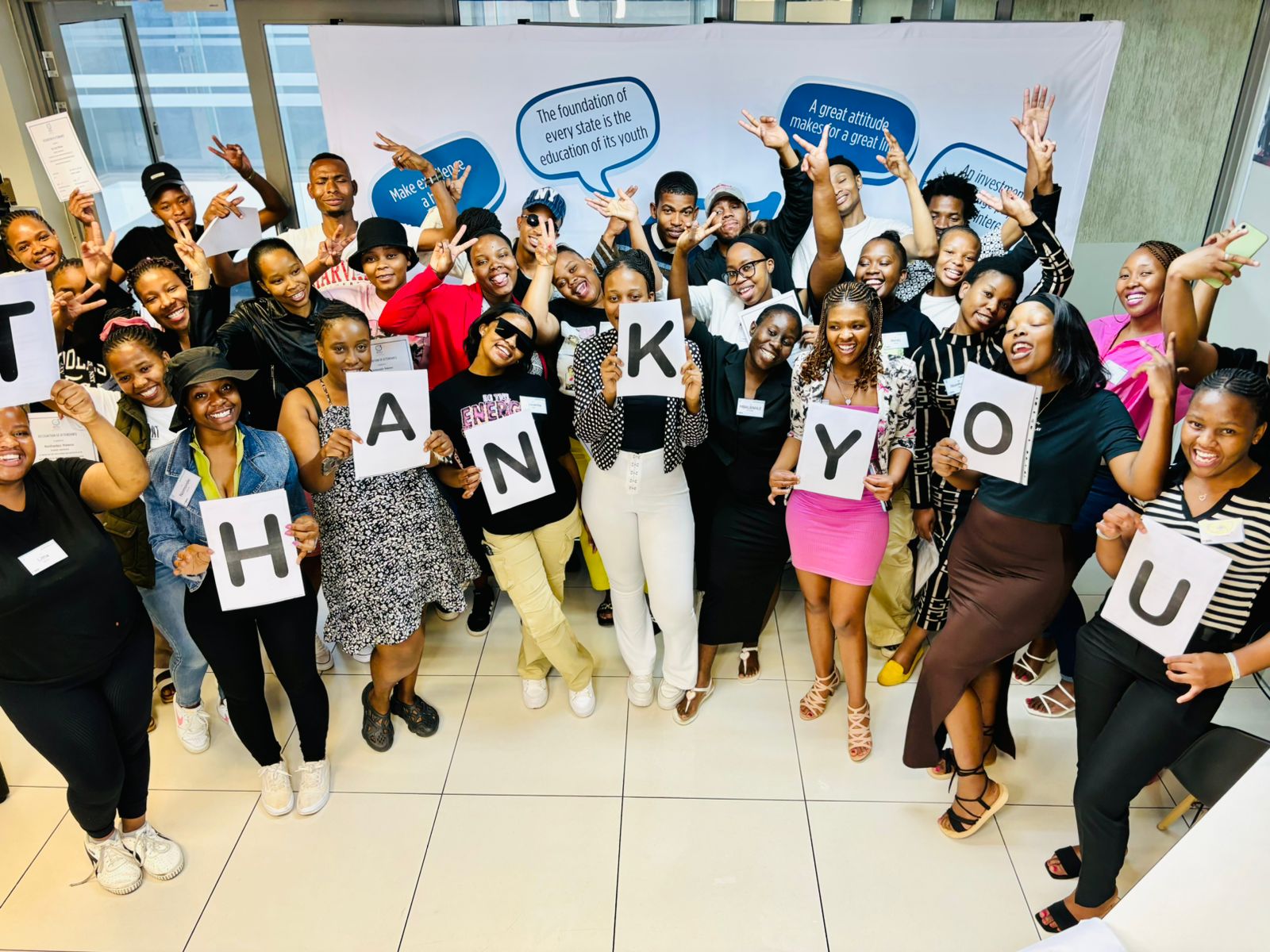 NQF 3 Wholesale and Retail Stock Control learners holding a Thank You sign for Ackermans